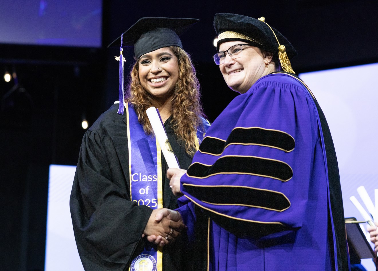Concordia University Texas student walking at commencement