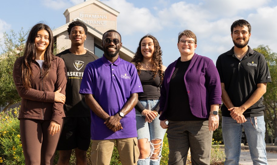 Dr. Kirk and students at the campus gatehouse