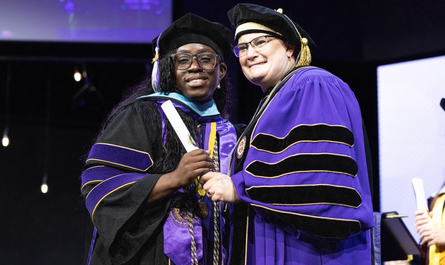 Dr. Kirk congratulates a new graduate