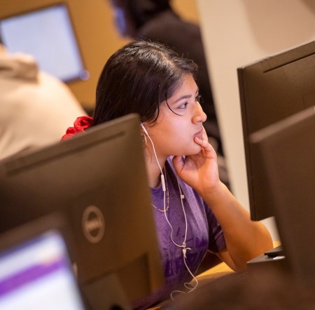 Concordia University Texas student using the computer lab on campus