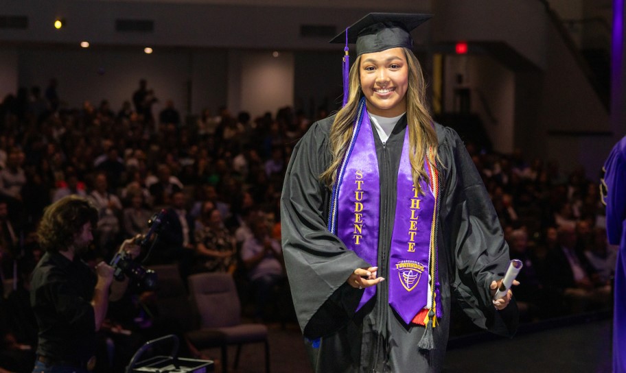 Concordia Texas student walking at commencement