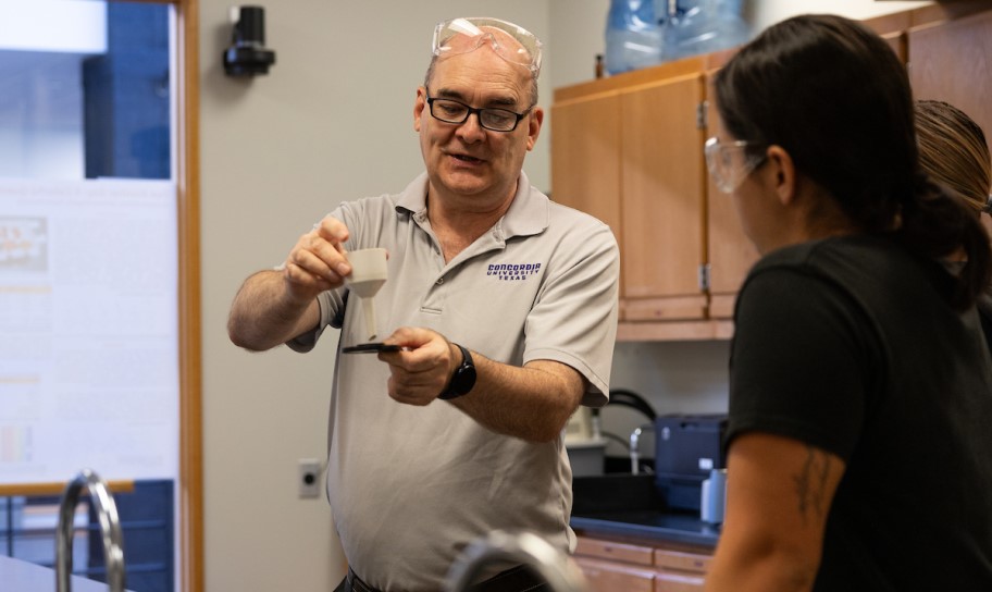 A chemistry professor give individual help to a student.