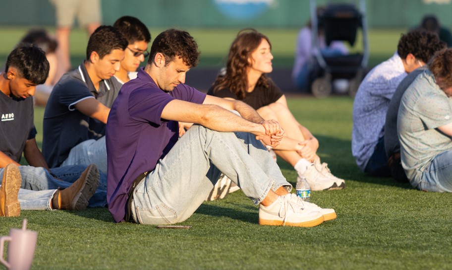 A group of worshippers at an outdoor worship on the CTX fields.