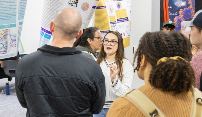 A student presenting their data to a professor