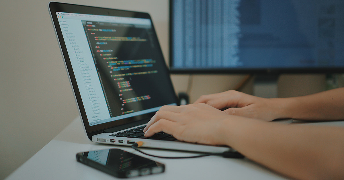 Person Coding on a Laptop