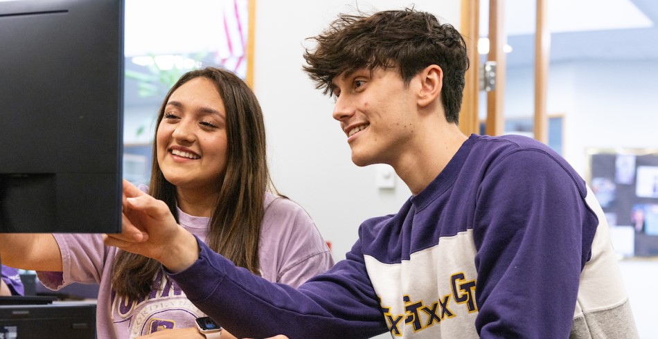 Two students collaborating with each other in the classroom