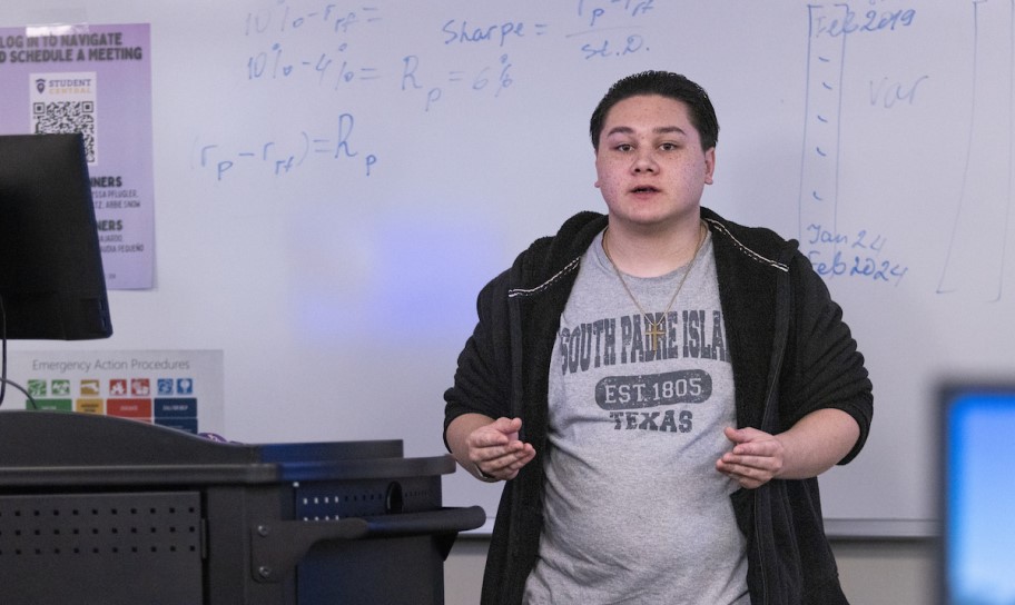A student leading a lecture in a classroom