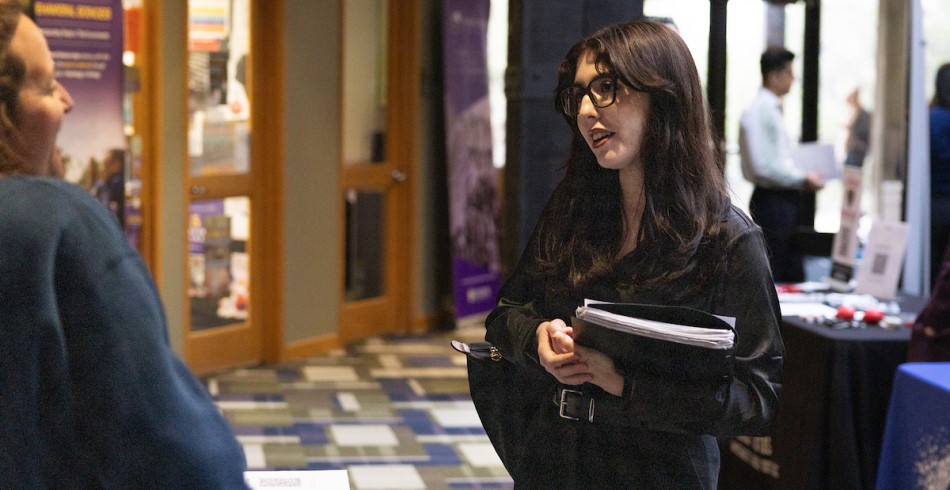 A career fair on campus with a pair of women conversing