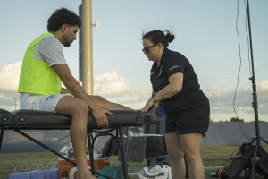 An athlete being checked out by a trainer