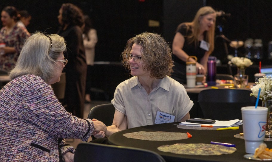 Two women getting to know each other at an event.