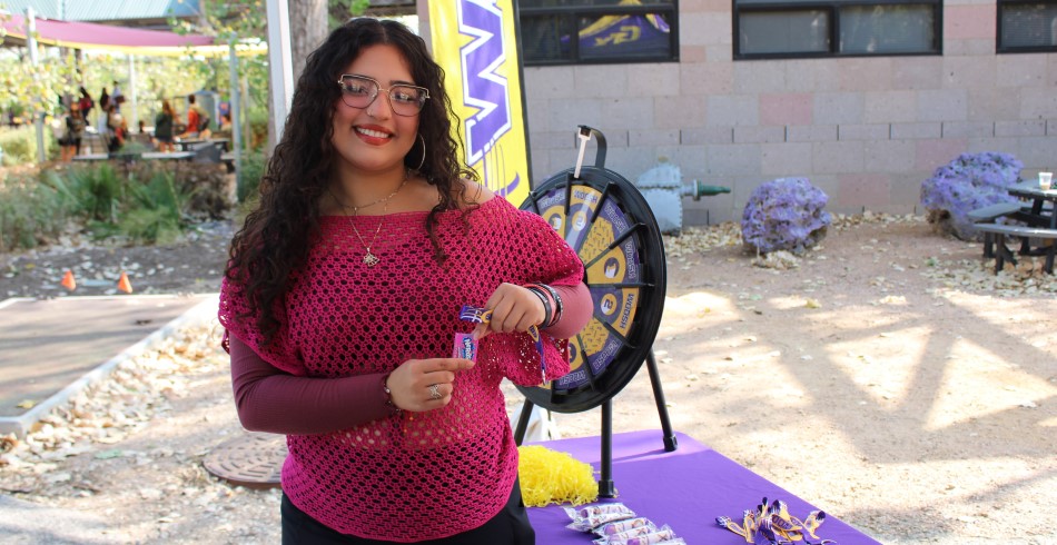 CTX student giving out swag with a prize wheel