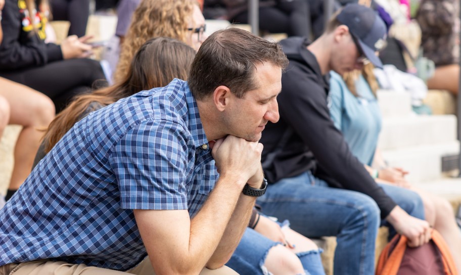 A Concordia University Texas chapel worship with people in prayer