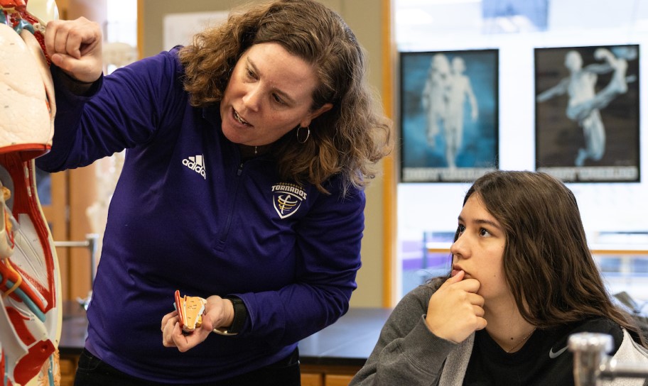 Professor guiding a student in lab